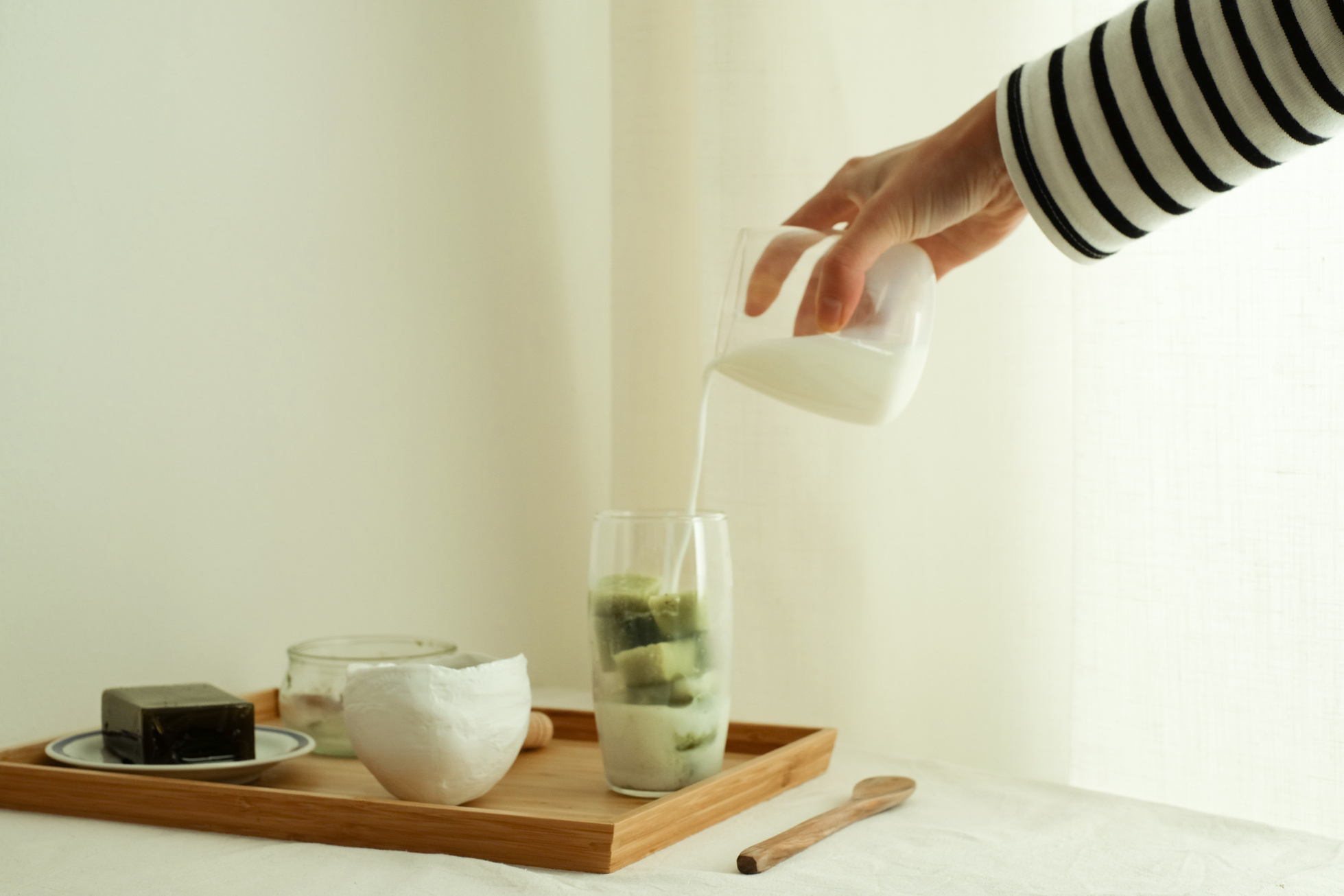 Woman Making Matcha Latte at Home